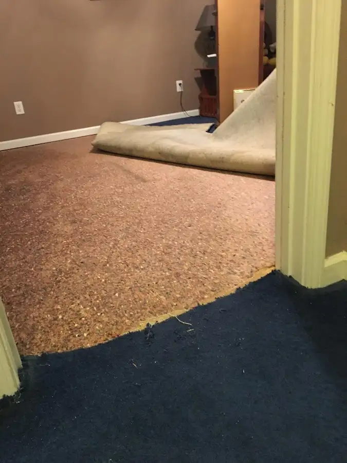 Carpet pad removal revealing water damage during Water Mitigation Services in Monterey Park